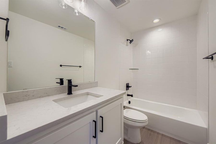 Bathroom with shower / tub combination, vanity, recessed lighting, and light wood-type flooring Bathroom with shower / tub combination, vanity, recessed lighting, and light wood-type flooring