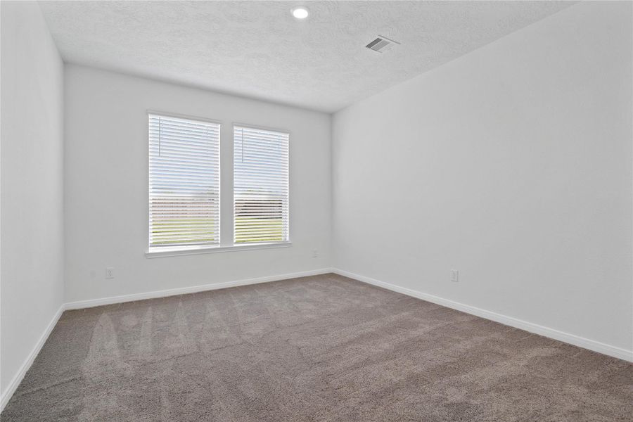 Relax and recharge in this stunning primary suite! Enjoy the comfort of plush carpeting, neutral-toned walls, high ceilings, and expansive windows with privacy blinds that fill the room with natural light.