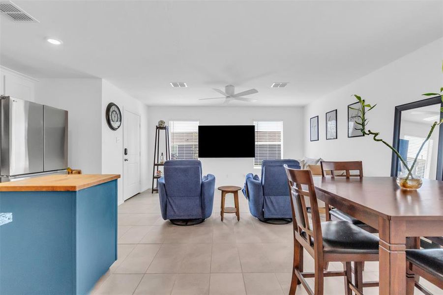 Dining space featuring light tile patterned flooring, a ceiling fan, and recessed lighting