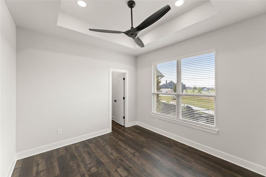 Spare room featuring a raised ceiling, dark wood-type flooring, recessed lighting, and ceiling fan Spare room featuring a raised ceiling, dark wood-type flooring, recessed lighting, and ceiling fan