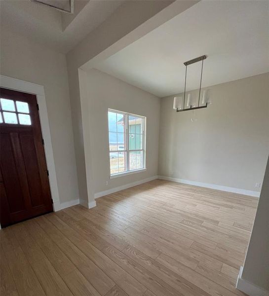 Entryway featuring a chandelier and light hardwood / wood-style flooring