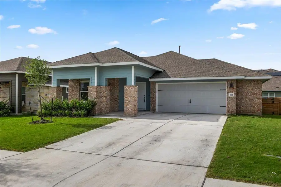 A well-maintained single-story home with a neat lawn and a concrete driveway leading to an attached garage. A well-maintained single-story home with a neat lawn and a concrete driveway leading to an attached garage.