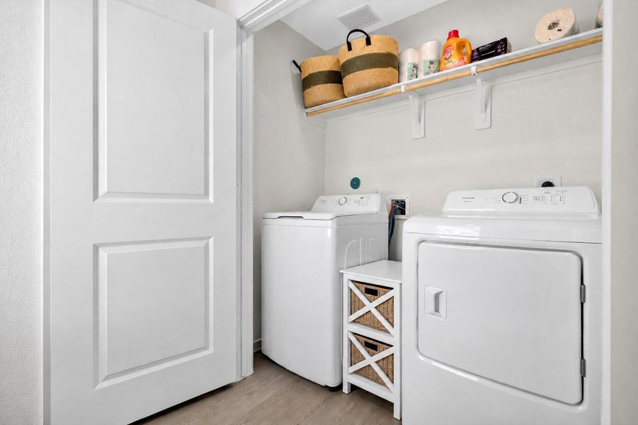 The laundry area adds everyday convenience with included washer and dryer. Laundry room on first floor