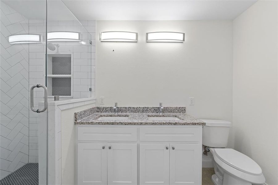 Owners Ensuite Bathroom with a shower with door, toilet, and vanity