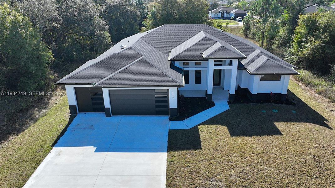 Front exterior of a new home in , Lehigh Acres, FL, highlighting curb appeal (Image 28).