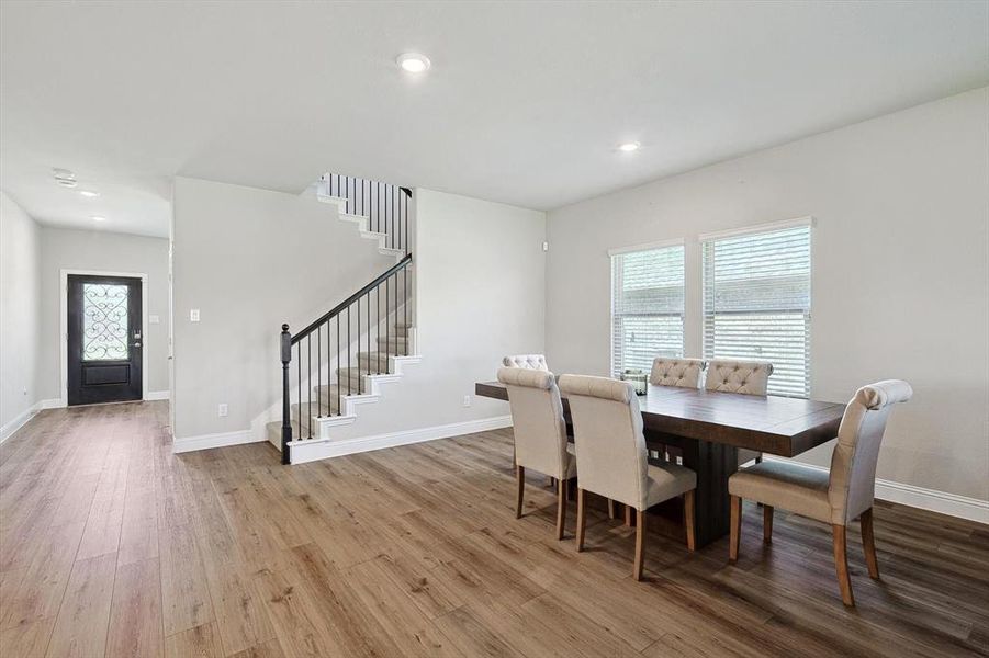 Dining area with hardwood / wood-style floors