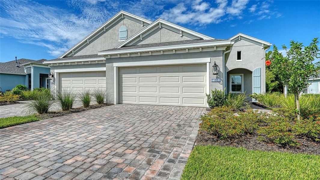 Front exterior of a new home in Wildleaf at North River Ranch, Parrish, FL, highlighting curb appeal (Image 2). Front exterior of a new home in Wildleaf at North River Ranch, Parrish, FL, highlighting curb appeal (Image 2).