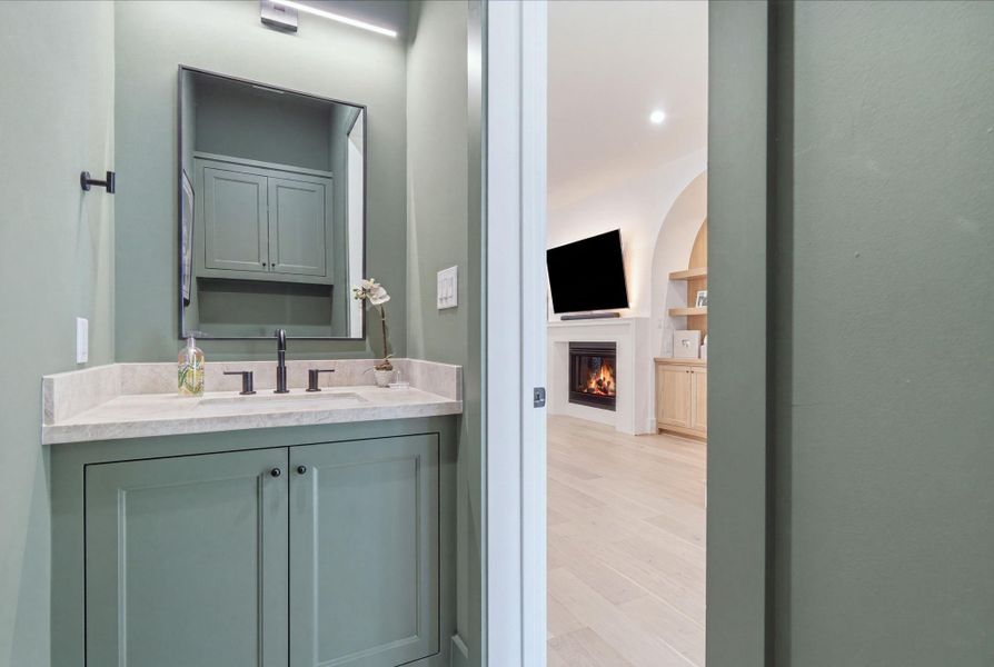 Luxurious 1/2 bath downstairs next to the family room. Luxurious 1/2 bath downstairs next to the family room.