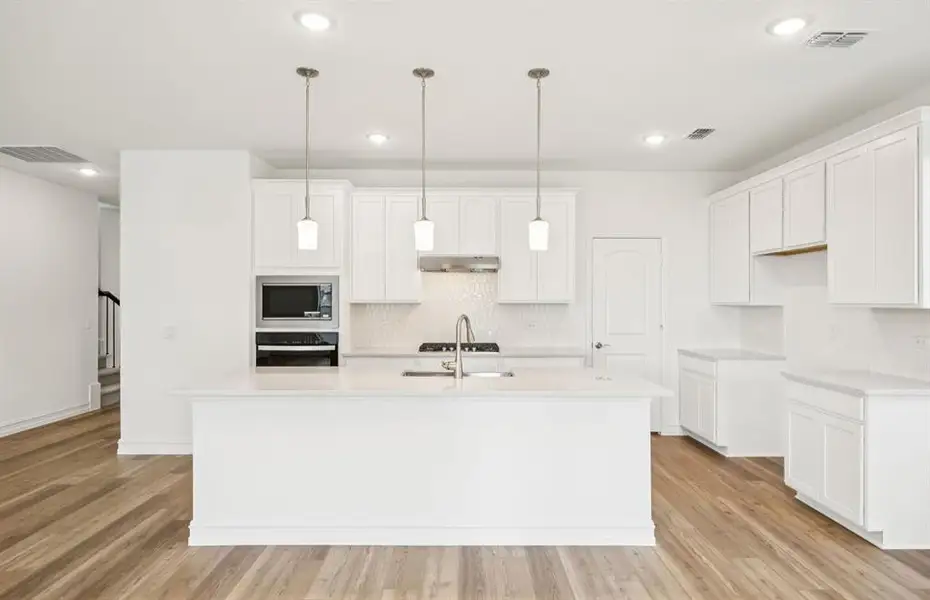 Open island kitchen with pendant lighting