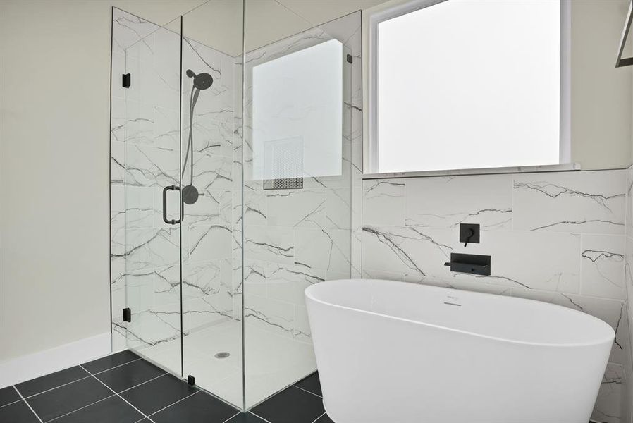 Bathroom featuring separate shower and tub and tile patterned floors