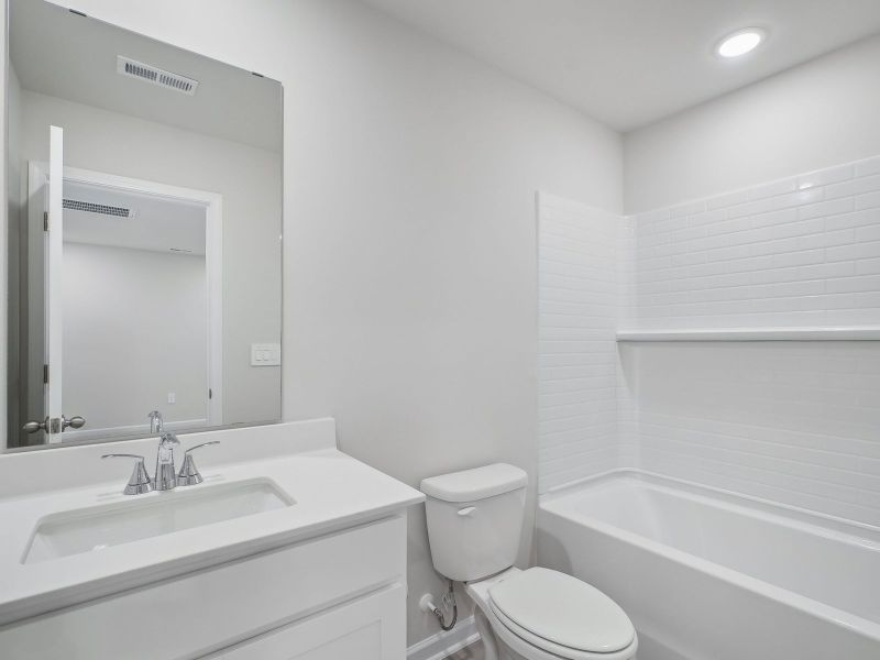 A secondary bathroom is adjacent to the secondary bedrooms.