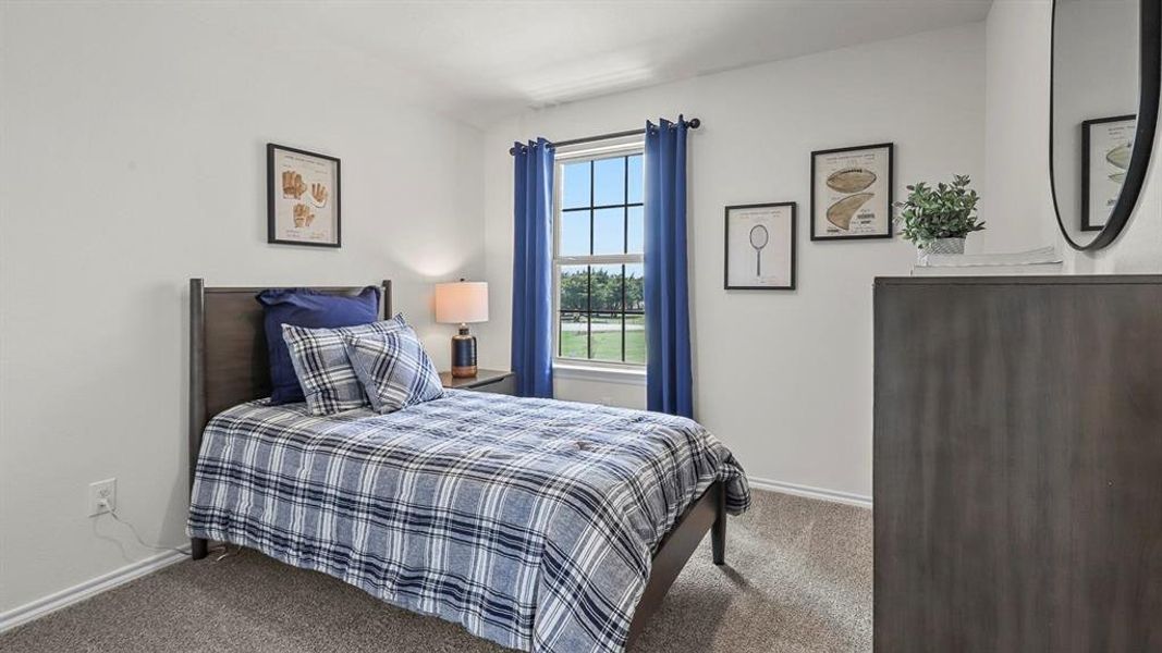 Bedroom with carpet floors and baseboards