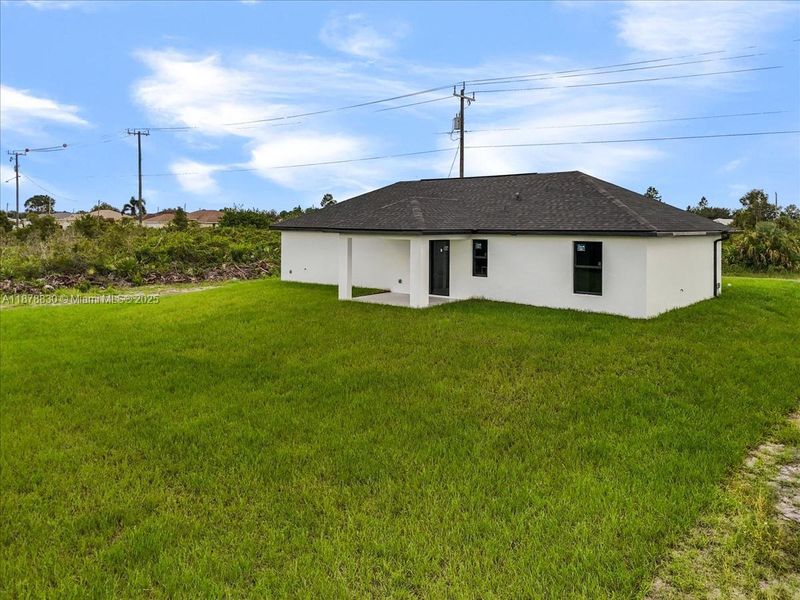 Front exterior of a new home in , Lehigh Acres, FL, highlighting curb appeal (Image 1).