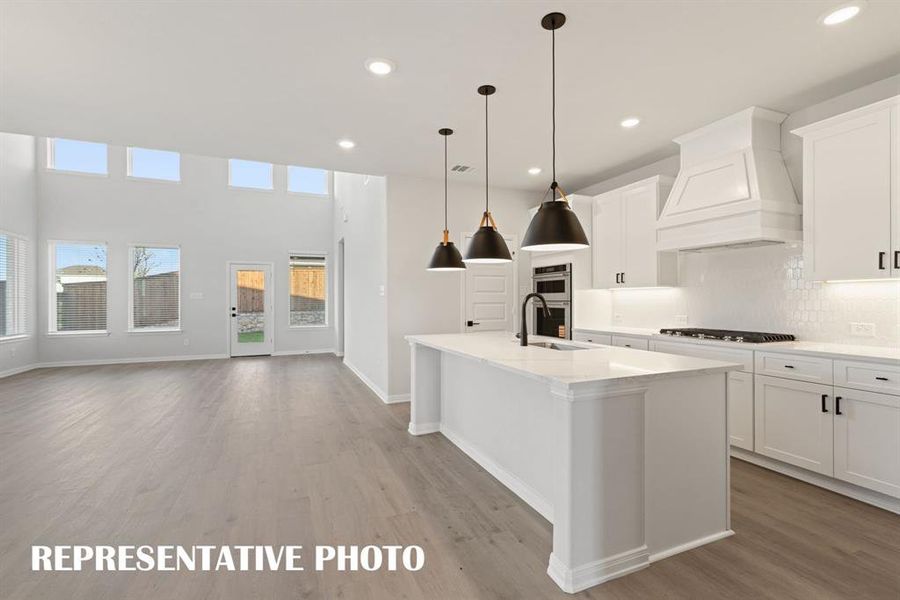The dining and family rooms are open to the kitchen creating a home that was designed for entertaining!  REPRESENTATIVE PHOTO