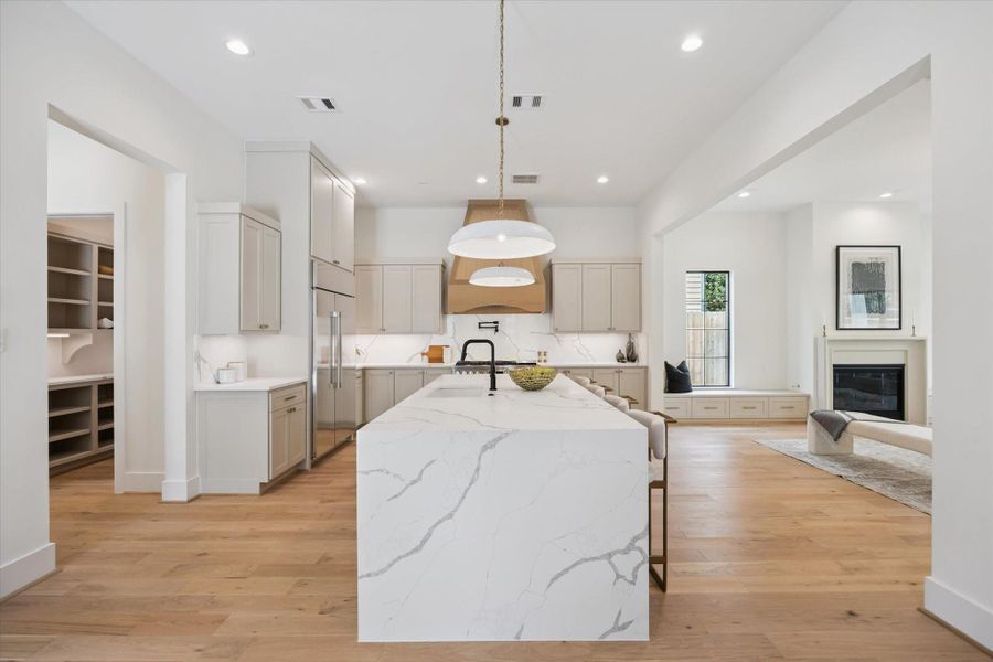 Center island is of Quartz with Waterfall edge detail. Notice how wide and open the space is as well as ceiling height and abundant lighting. Center island is of Quartz with Waterfall edge detail. Notice how wide and open the space is as well as ceiling height and abundant lighting.