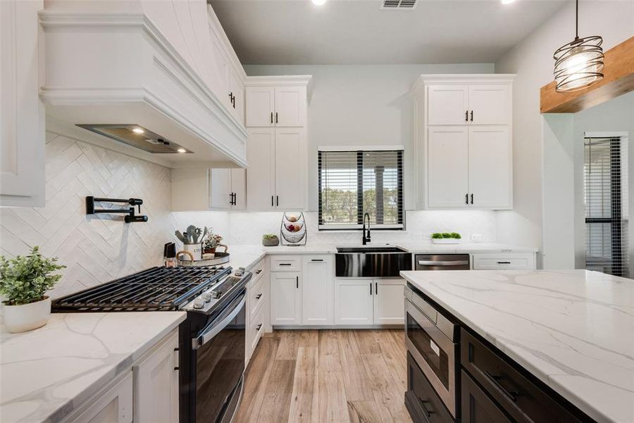 This kitchen is absolutely incredible. Modern finish-out, huge quartz island and generous storage, as well as a walk-in pantry.