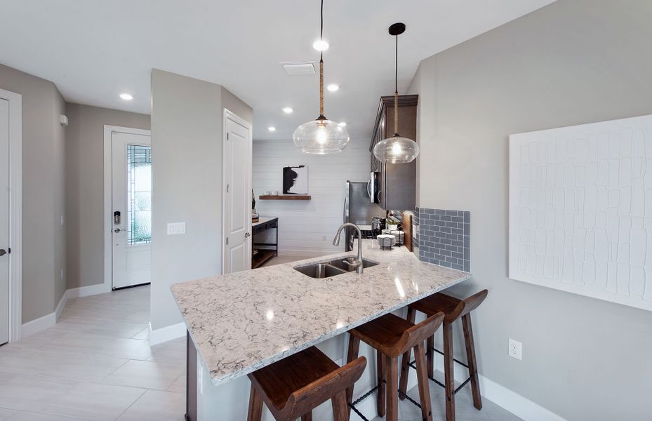 Kitchen with stainless steel appliances and decorative backsplash Kitchen with stainless steel appliances and decorative backsplash