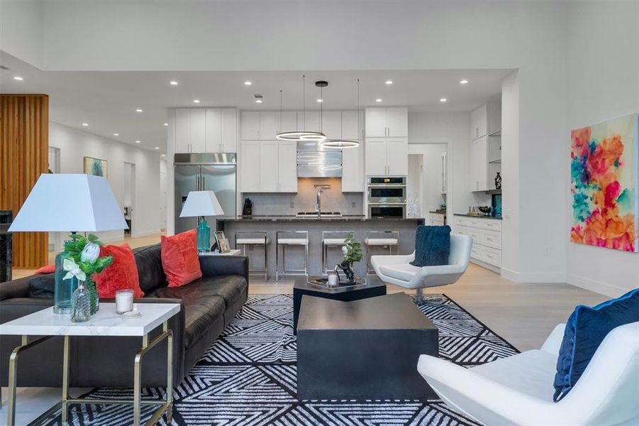 Living room featuring light wood finished floors and recessed lighting Living room featuring light wood finished floors and recessed lighting