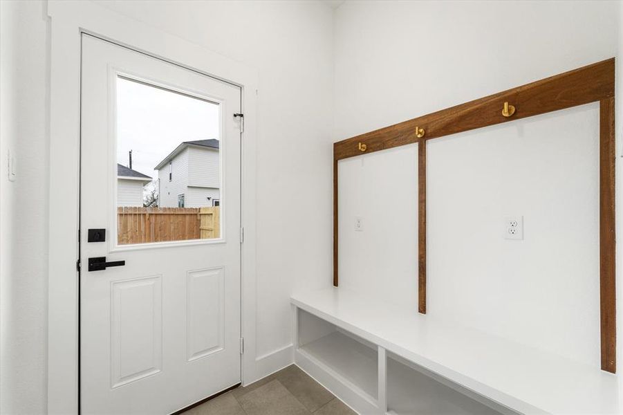 The mudroom we all need! Stylish hooks, additional outlets and storage easily accessible from your second backyard entry.