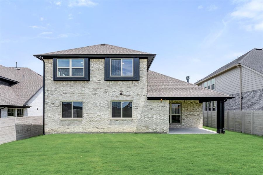 Front exterior of a new home in Painted Tree Woodland District 50, McKinney, TX, highlighting curb appeal (Image 2). Front exterior of a new home in Painted Tree Woodland District 50, McKinney, TX, highlighting curb appeal (Image 2).