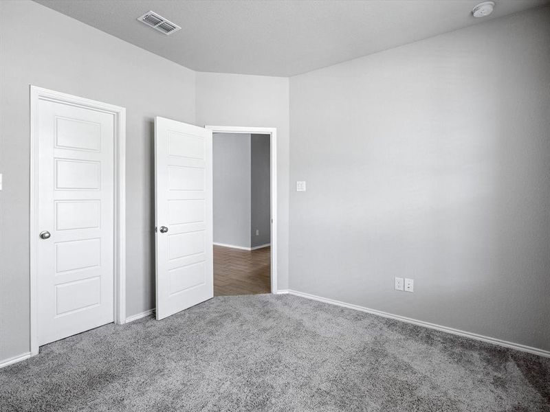 Unfurnished bedroom with carpet and baseboards Unfurnished bedroom with carpet and baseboards
