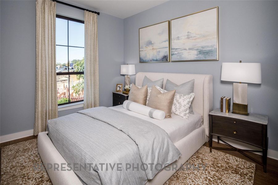 Bedroom with multiple windows and wood finished floors