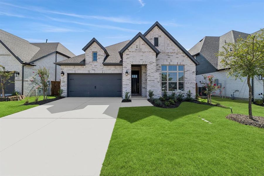Front exterior of a new home in Sandbrock Ranch, Aubrey, TX, highlighting curb appeal (Image 1).