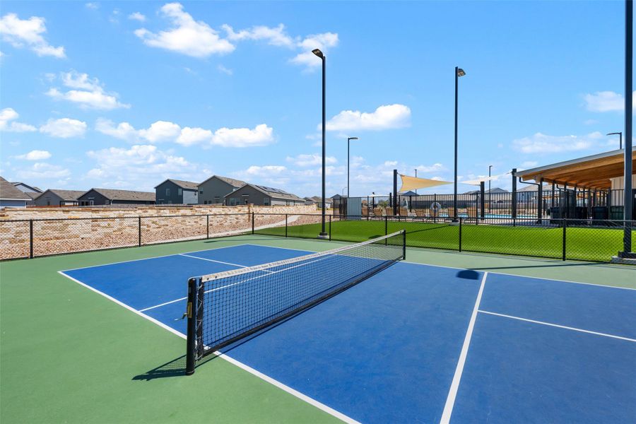 A professionally paved recreational court provides outdoor activity space under sunny blue skies. A professionally paved recreational court provides outdoor activity space under sunny blue skies.