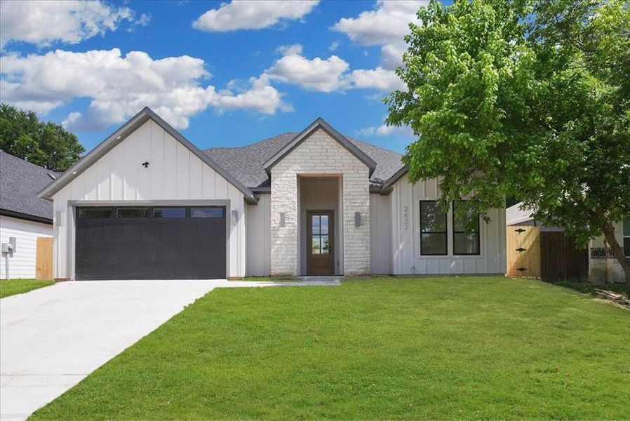 Contemporary exterior featuring white vertical board and batten siding with stone accents Contemporary exterior featuring white vertical board and batten siding with stone accents