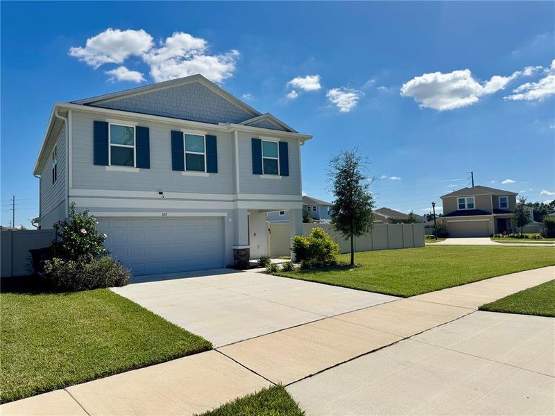 Front exterior of a new home in Marion Creek, Haines City, FL, highlighting curb appeal (Image 1).