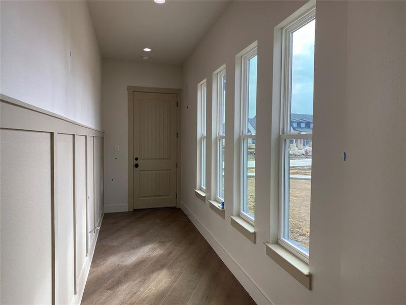 Hallway with light hardwood / wood-style flooring