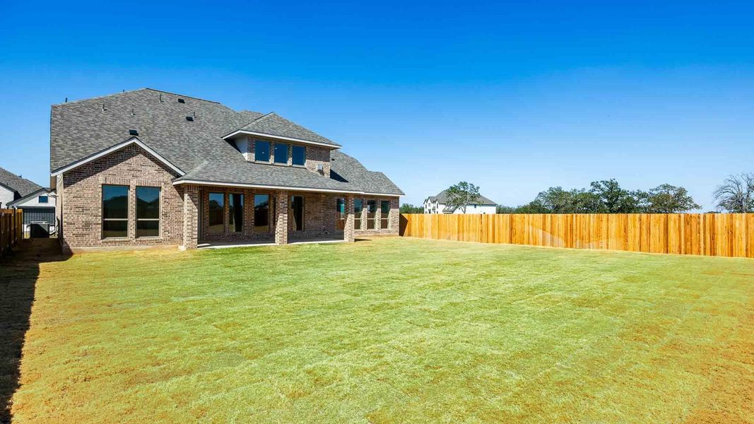 Rear view of property featuring a fenced backyard, a patio area, a shingled roof, and brick siding Rear view of property featuring a fenced backyard, a patio area, a shingled roof, and brick siding