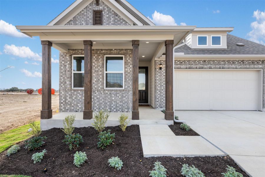 Front exterior of a new home in Rolling Glen, Hutto, TX, highlighting curb appeal (Image 18).