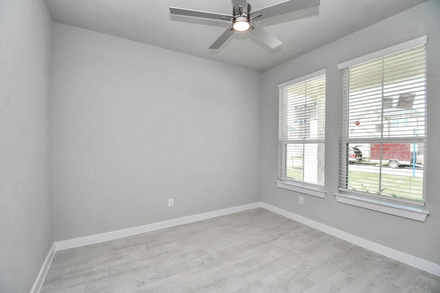 Secondary bedroom features plush carpeting, large windows that let in plenty of natural light, bright paint, and spacious closets. Sample photo of completed home with similar floor plan. Actual colors and selections may vary. Secondary bedroom features plush carpeting, large windows that let in plenty of natural light, bright paint, and spacious closets. Sample photo of completed home with similar floor plan. Actual colors and selections may vary.