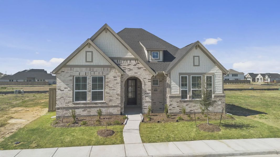 Representative exterior photo of a completed home built from the Nicklaus by Chesmar Homes in Riceland Alley Loads, Mont Belvieu, TX (Image 31).