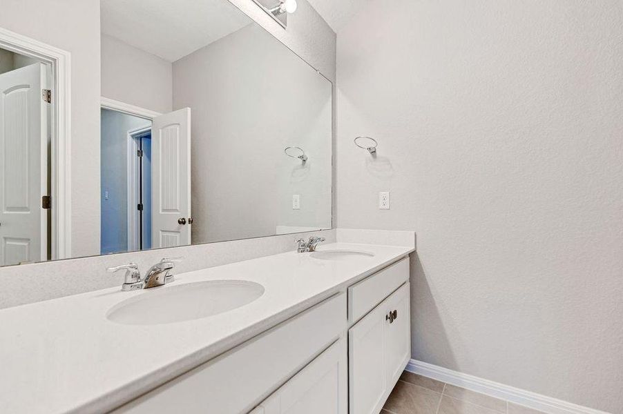Bathroom with double vanity and light tile patterned flooring Bathroom with double vanity and light tile patterned flooring
