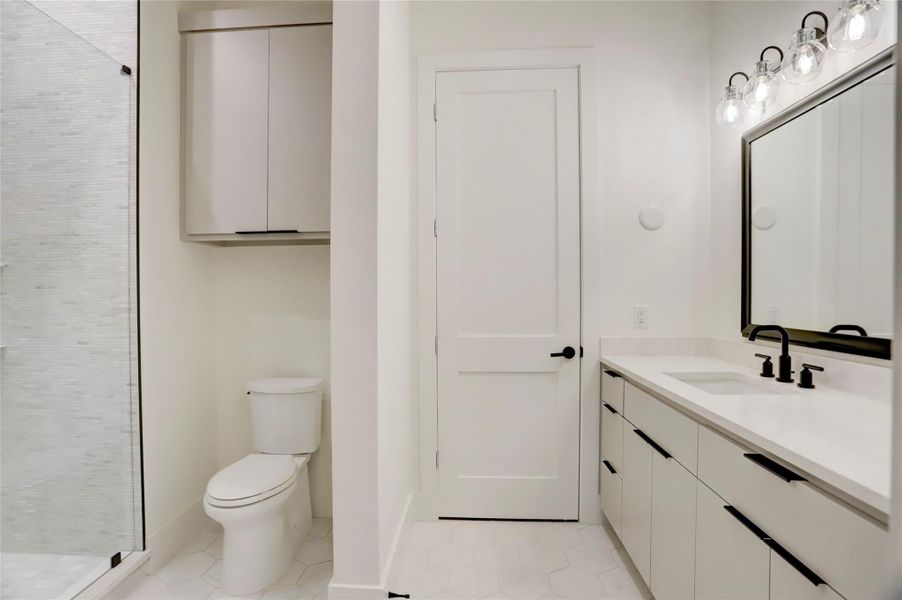 The main utility room is located between the second floor bedrooms and offers plenty of cabinet and counter space with a sink.