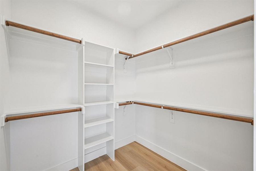 Spacious closet with light wood-style flooring