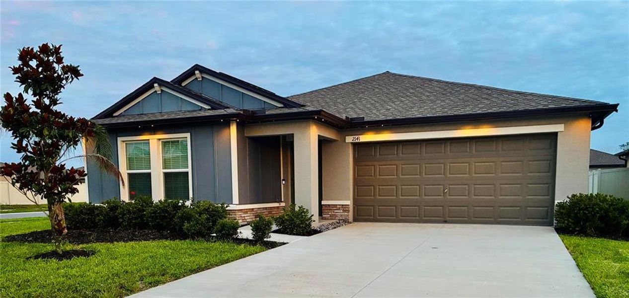 Front exterior of a new home in Two Rivers, Zephyrhills, FL, highlighting curb appeal (Image 22).