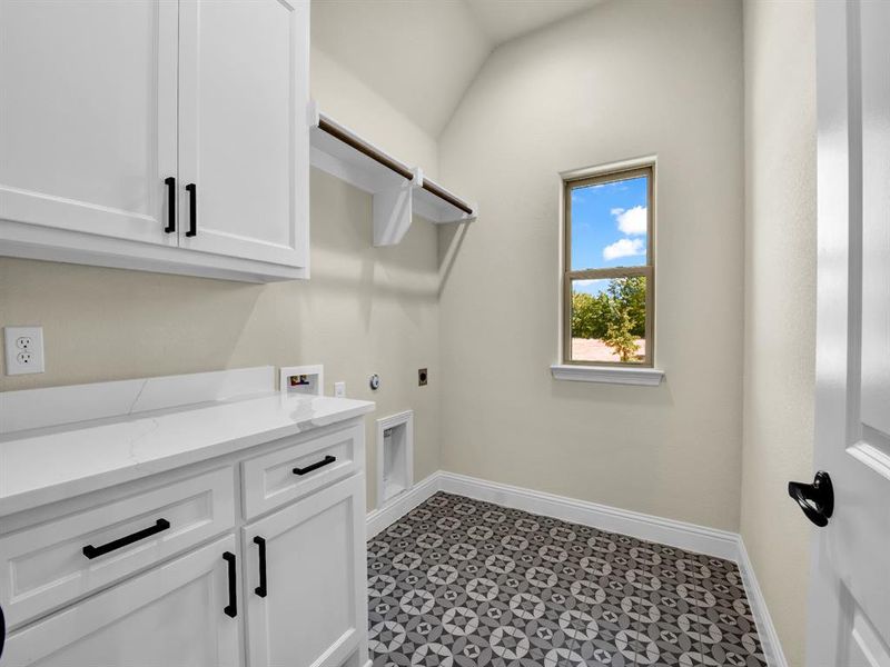 Clothes washing area with hookup for a washing machine, cabinets, and hookup for an electric dryer