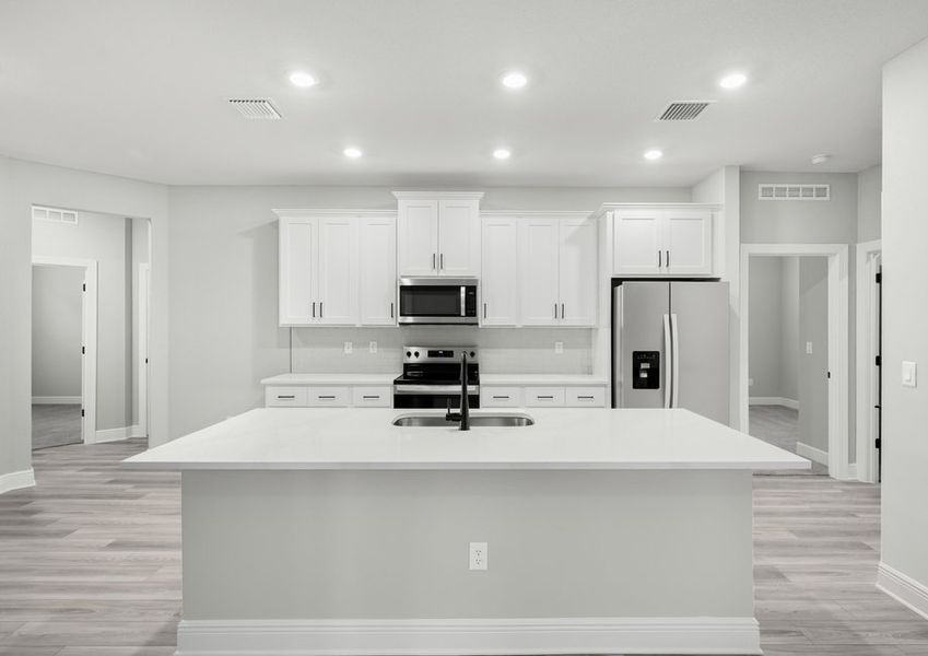 The kitchen features a sprawling kitchen island to create your family's favorite meals