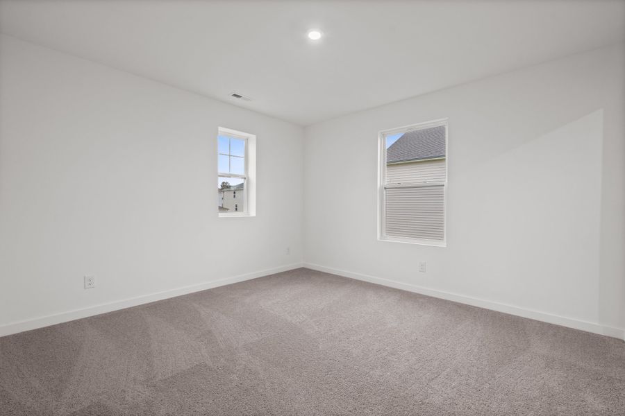 A room with a window and a carpet. A room with a window and a carpet.