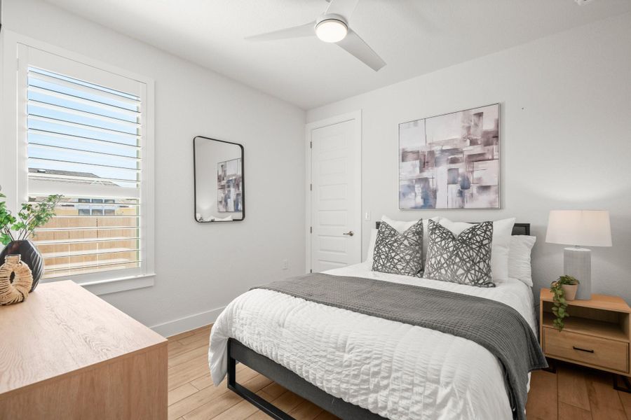 Bedroom with light wood-style flooring and ceiling fan