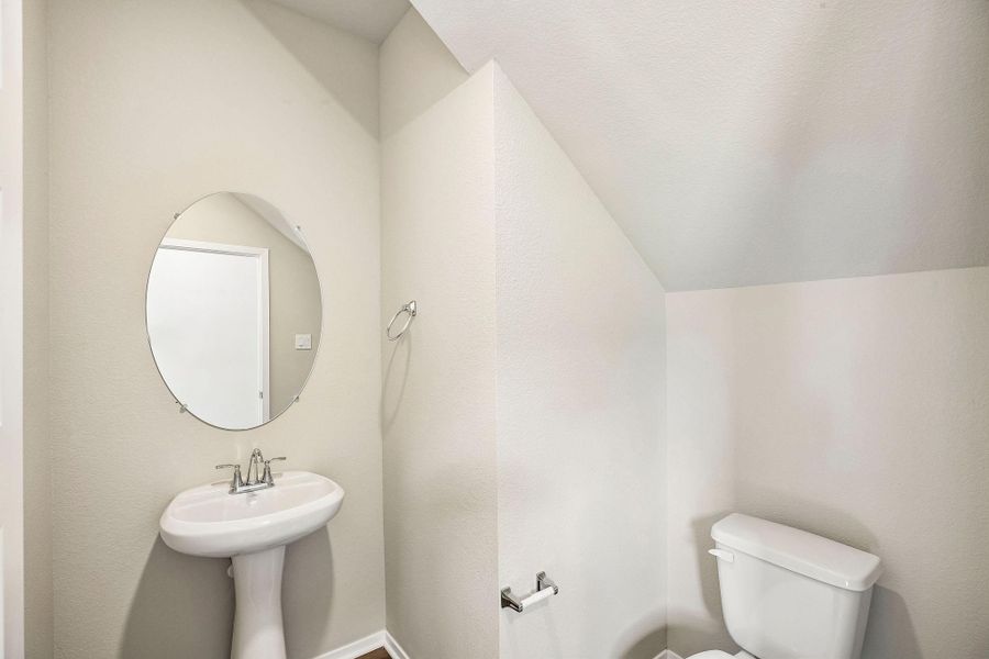 A comfortable secondary half bath provides easy access for family and visitors. A comfortable secondary half bath provides easy access for family and visitors.