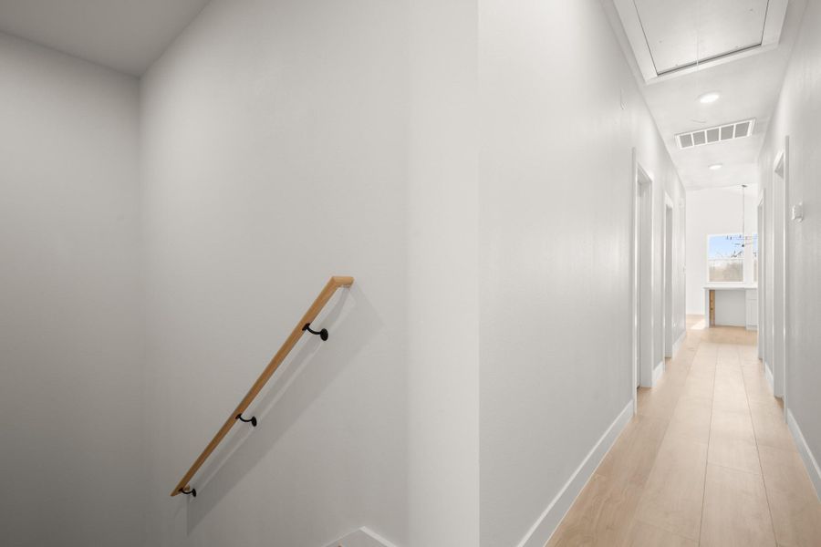 Corridor with light wood finished floors and recessed lighting