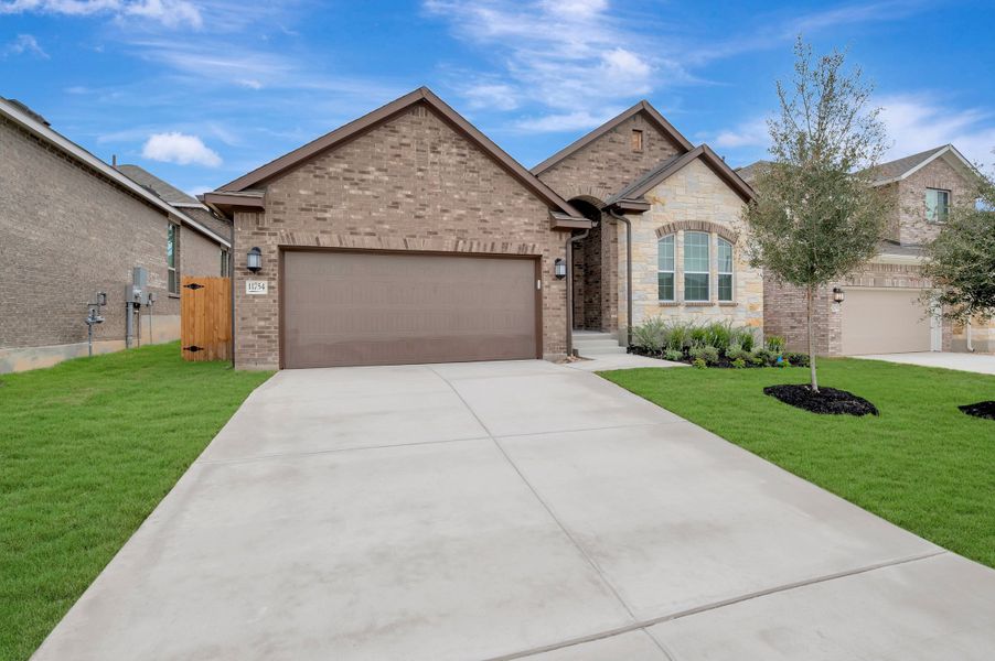 Front exterior of a new home in Davis Ranch 50', San Antonio, TX, highlighting curb appeal (Image 2). Front exterior of a new home in Davis Ranch 50', San Antonio, TX, highlighting curb appeal (Image 2).