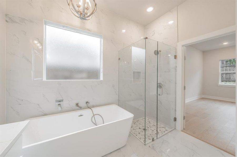 Full bath with a marble finish shower, a freestanding tub, marble finish floors, recessed lighting, and vanity