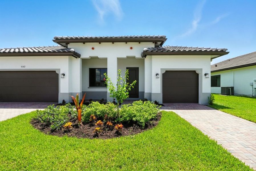 Front exterior of a new home in Maple Ridge, Ave Maria, FL, highlighting curb appeal (Image 1).