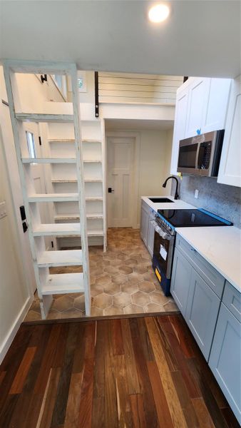 Living room looking into kitchen/entry area. Living room looking into kitchen/entry area.