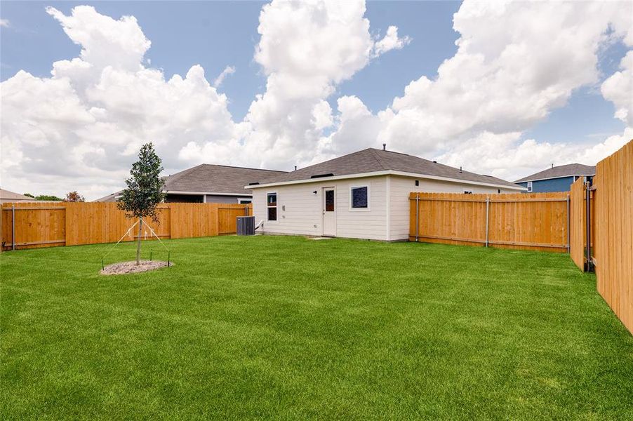 Back of house with a fenced backyard, a shingled roof, and a patio Back of house with a fenced backyard, a shingled roof, and a patio